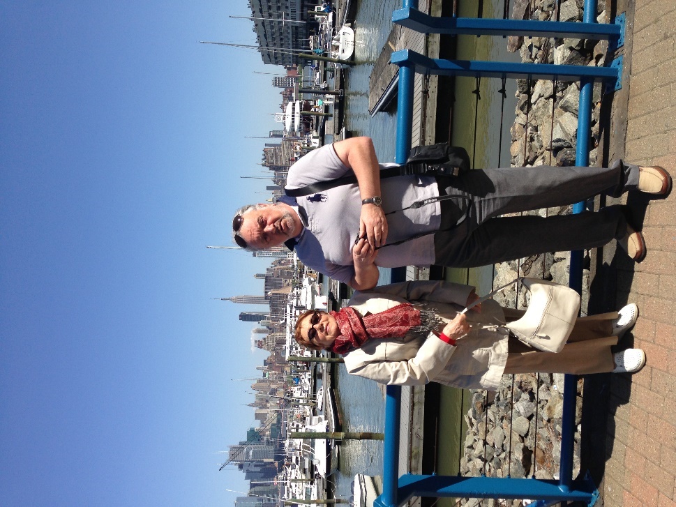 A person and person standing on a blue railingAI-generated content may be incorrect.
