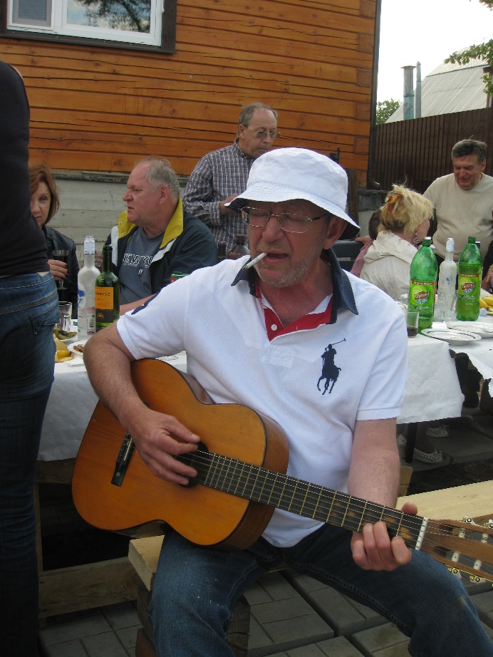 A person playing guitar and smoking a cigaretteAI-generated content may be incorrect.