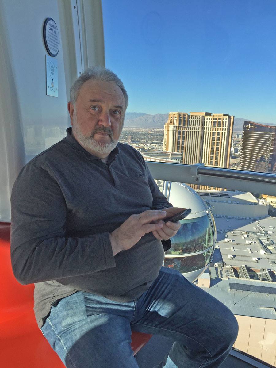 A person sitting on a balcony looking at a phoneAI-generated content may be incorrect.