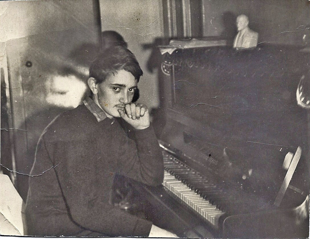 A person sitting at a pianoAI-generated content may be incorrect.
